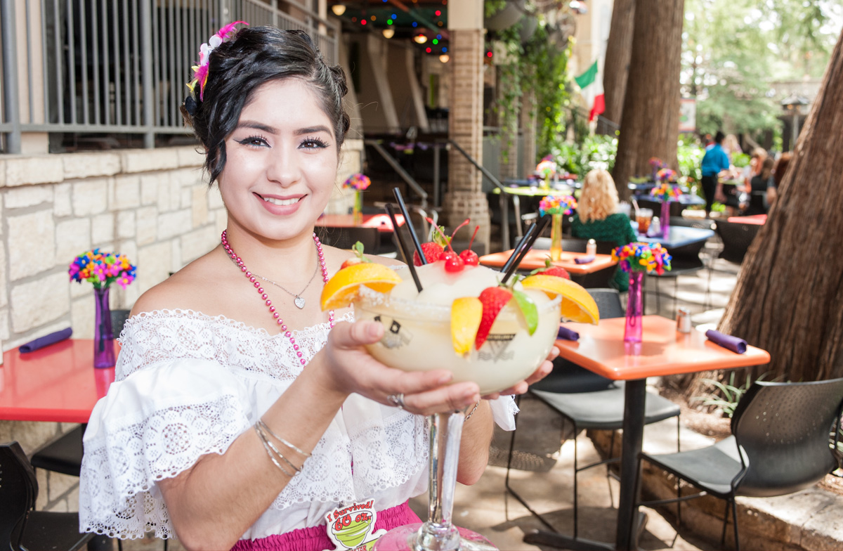 A waitress holds up a margarita