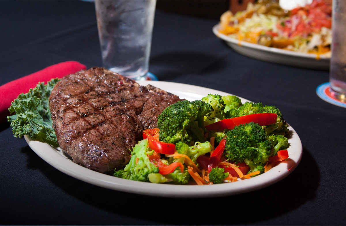 A steak with a side of vegetables